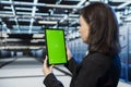 Green screen tablet used by data center admin to do checkup Royalty Free Stock Photo