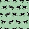 Green seamless pattern with black horses silhouettes Royalty Free Stock Photo