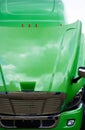 Green semi truck cab with open hood and clouds reflection Royalty Free Stock Photo