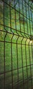 Green shading net for sunlight protection, on a steel fence Royalty Free Stock Photo