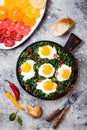 Green shakshuka with spinach, kale and peas. Healthy delicious breakfast. Top view, overhead, flat lay. Royalty Free Stock Photo