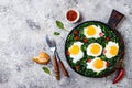 Green shakshuka with spinach, kale and peas. Healthy delicious breakfast. Top view, overhead, flat lay.