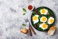 Green shakshuka with spinach, kale and peas. Healthy delicious breakfast. Top view, overhead, flat lay. Royalty Free Stock Photo