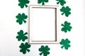 Green shamrock frame on white background. Three leaf clover, top view. Minimal concept. Royalty Free Stock Photo