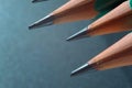 Green sharpened wooden pencils with black lead on a dark textured background. close-up Royalty Free Stock Photo