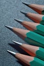 Green sharpened wooden pencils with black lead on a dark textured background. close-up Royalty Free Stock Photo