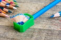 Green sharpener on wooden background Royalty Free Stock Photo