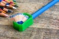 Green sharpener on wooden background Royalty Free Stock Photo