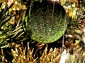 Green shining balls and decorations on a Christmas tree