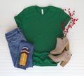 Green shirt top view and styled with Christmas items - white background