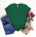 Green shirt top view and styled with Christmas items - white background