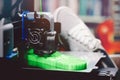 Green shoe sole is 3D-printed at home with a FDM-printer.