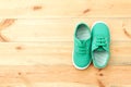 Green shoes on wooden floor.