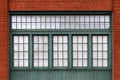 green shop windows red brick warehouse wall Royalty Free Stock Photo
