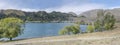 Green shore and dam at Benmore lake, New Zealand Royalty Free Stock Photo