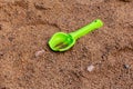 Green Shovel. Forgotten toy after rain in the sandbox
