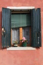 Green shutter window on colorful wall