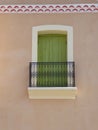Green shuttered window and balcony