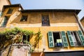 Green Shutters on Open Windows of Yellow Plaster Building Royalty Free Stock Photo