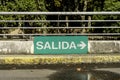 Green sign that says Exit in Spanish in a parking lot Royalty Free Stock Photo