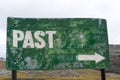 Green sign with the word past and arrow