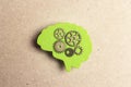 Green silhouette human brain with gears