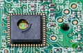 Green silicon die and gold wires inside round hole of integrated circuit Royalty Free Stock Photo