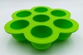 Green silicone molds for cupcakes and muffins, isolated on white