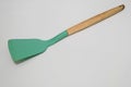 Green Silicone Spatula with Wooden Handle on White Background
