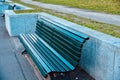 Green sitting empty wooden bench around a park in Berlin