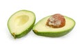 Green avocado fruit cut in half on a white background