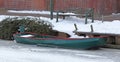 Green small boat stuck in frozen ice Royalty Free Stock Photo