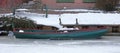 Green small boat stuck in frozen ice Royalty Free Stock Photo