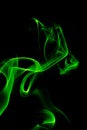 Green smoke on a black background, abstract smoke swirls Royalty Free Stock Photo