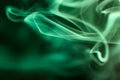 Green smoke swirling against a dark background