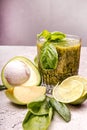 Green smoothie of avocado, spinach, basil, lime, green apple on gray background. Healthy diet eatin concept Royalty Free Stock Photo
