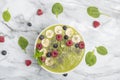 Green Smoothie Bowl with Banana, kiwi, chia seeds, blueberries, raspberries and spinach. Healthy breakfast. Detox concept. Royalty Free Stock Photo