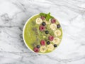 Green Smoothie Bowl with Banana, kiwi, chia seeds, blueberries, raspberries and spinach. Healthy breakfast. Detox concept. Royalty Free Stock Photo