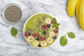 Green Smoothie Bowl with Banana, kiwi, chia seeds, blueberries, raspberries and spinach. Healthy breakfast. Detox concept. Royalty Free Stock Photo