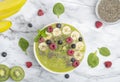 Green Smoothie Bowl with Banana, kiwi, chia seeds, blueberries, raspberries and spinach. Healthy breakfast. Detox concept. Royalty Free Stock Photo