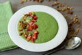 Green smoothie bowl with banana, strawberry, spinach, kale, kiwi, coconut milk garnished with homemade granola and fruits Royalty Free Stock Photo