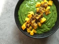 Green smoothie bowl with chopped mango and chia seeds Royalty Free Stock Photo