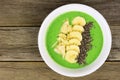 Green smoothie bowl on a wood background Royalty Free Stock Photo