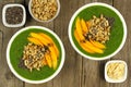 Green smoothie bowls with mangoes on wood background Royalty Free Stock Photo