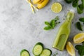 Green smoothie detox drink in glass bottle with fresh spinach, cucumber, banana and lime. Copy space, top view Royalty Free Stock Photo