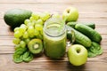 Green smoothie in glass jar with fruits Royalty Free Stock Photo