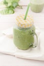 Green smoothie in a glass jar with lid and a straw Royalty Free Stock Photo