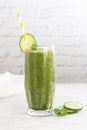 Green smoothie glass with spinach, banana blueberry, cucumber, avocado, bright kitchen background Royalty Free Stock Photo