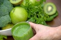 Green smoothie in hand Royalty Free Stock Photo