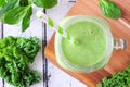 Green smoothie with kale and spinach close up overhead view on a white wood background Royalty Free Stock Photo